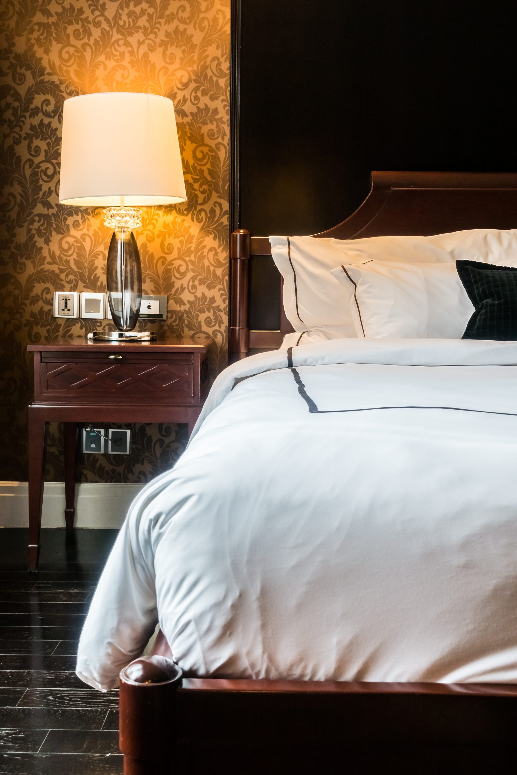 White pillow on bed with table light lamp decoration in bedroom interior